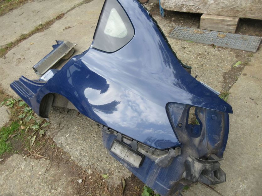 RENAULT THALIA II 2011 r. BŁOTNIK LEWY TYŁ DV460